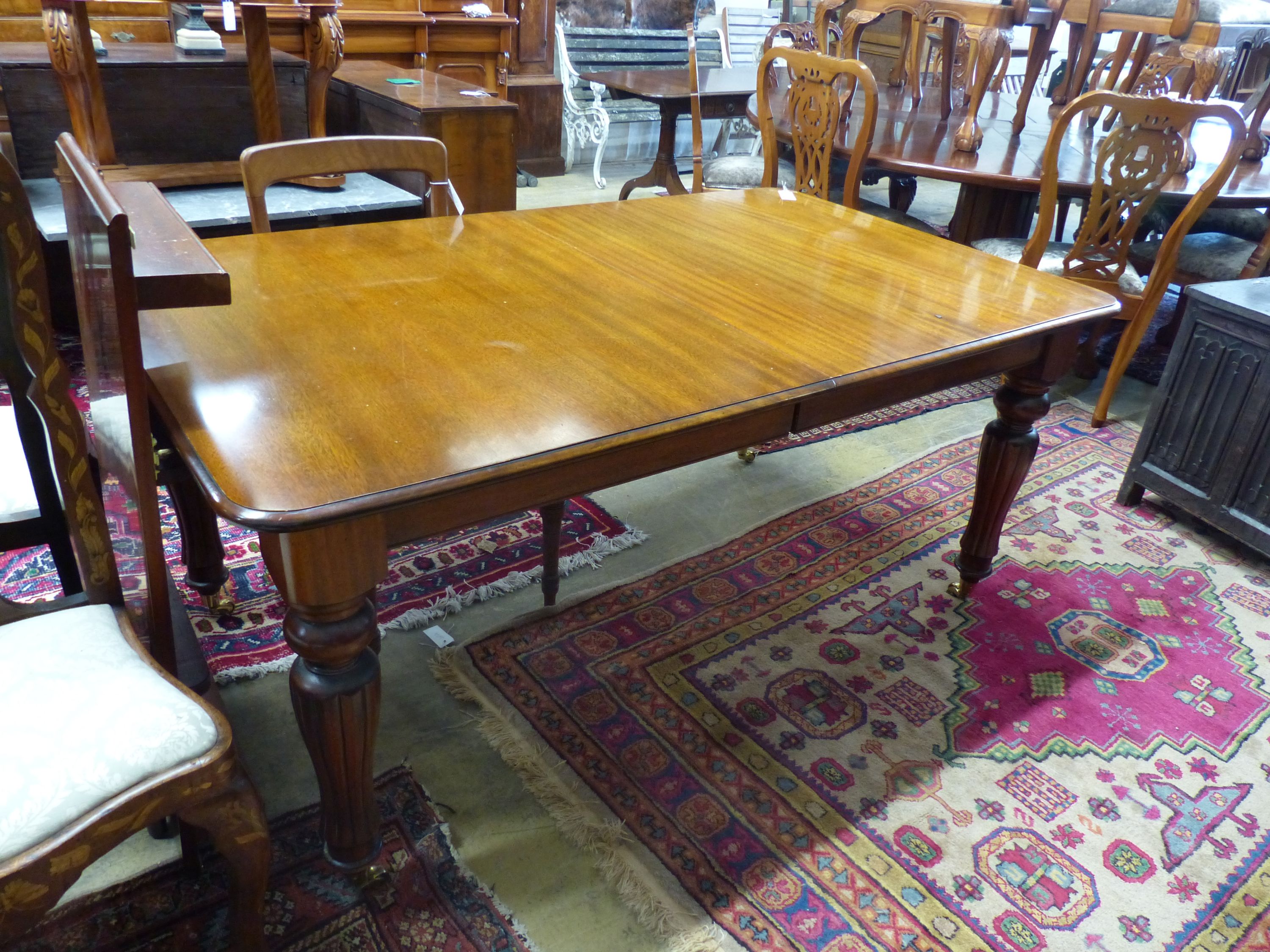 A Victorian mahogany extending dining table (one additional leaf), 250cm extended, width 100cm, height 76cm